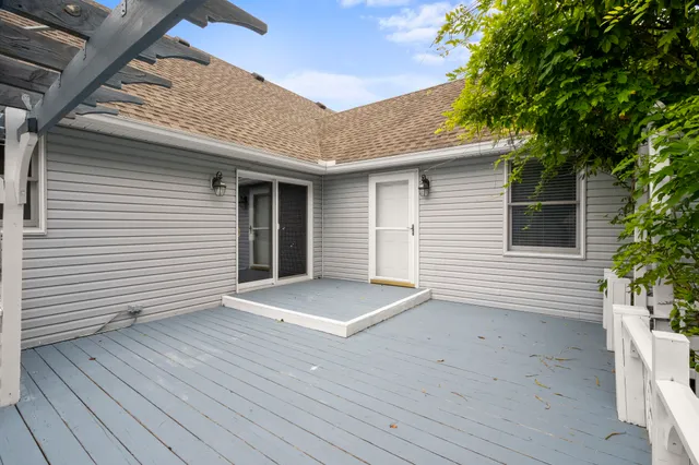 a view of a house with a wooden deck