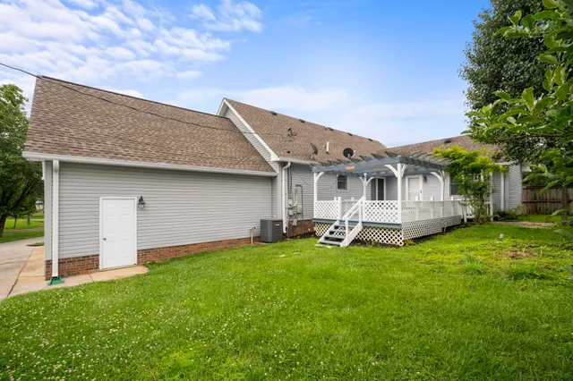 a view of a house with a yard and sitting area