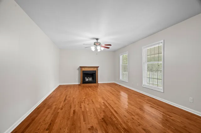 a view of an empty room with glass door and a window