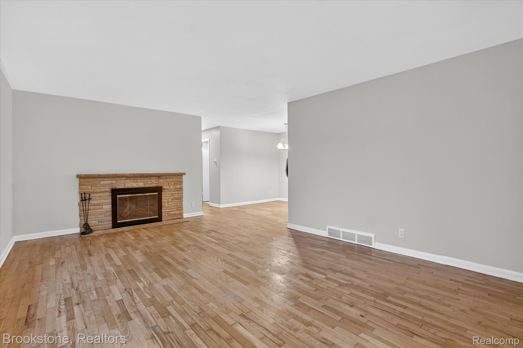 4547 Marlborough Road Okemos, MI 48864 - Photo 7 of 55 Unfurnished living room featuring a fireplace and light wood-type flooring