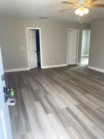a view of an empty room and wooden floor