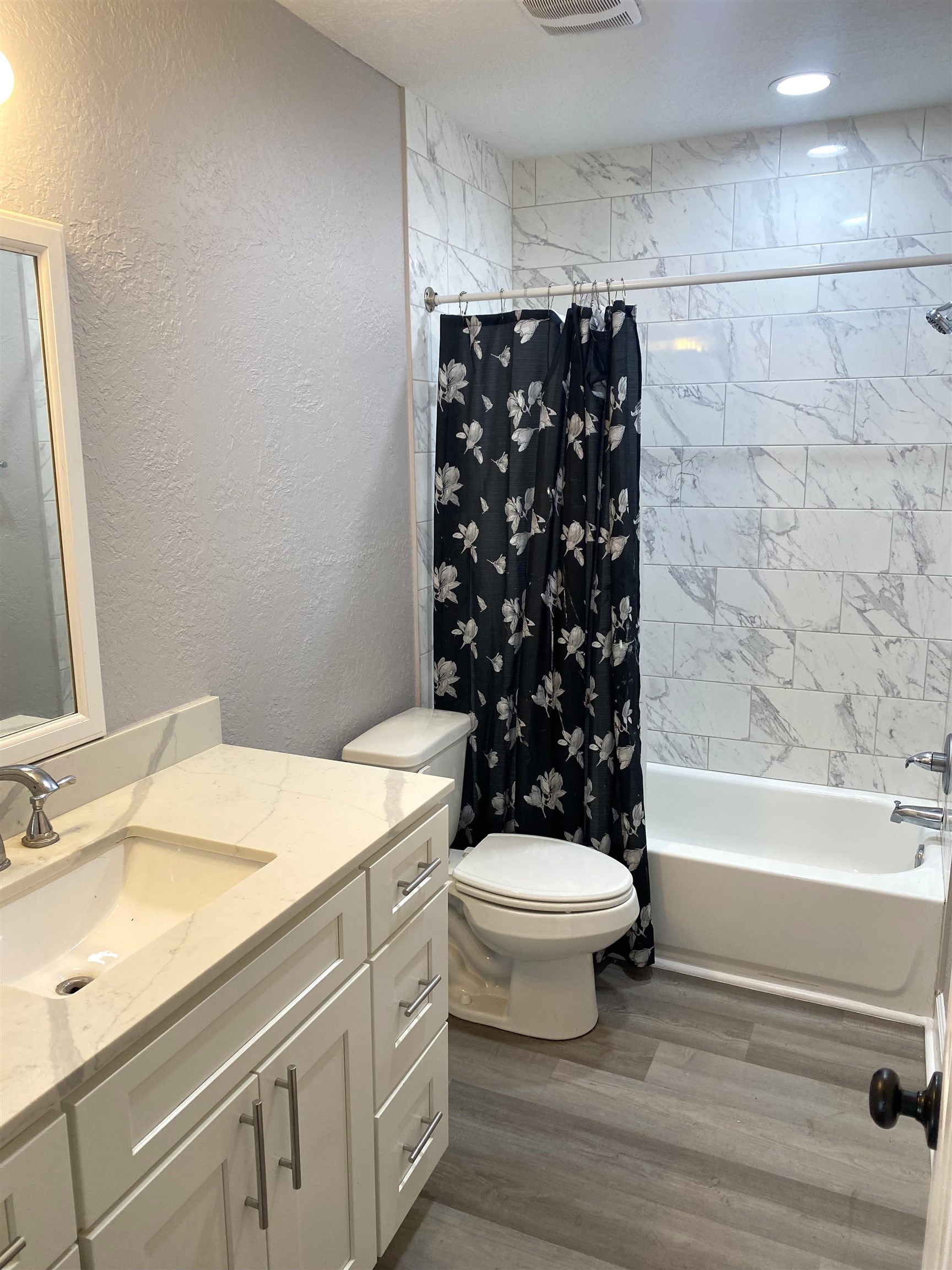 1870 Adams Acres Road St. Augustine, FL 32084 - Photo 7 of 12 Bathroom with a textured wall, vanity, shower / tub combo, and dark wood-type flooring