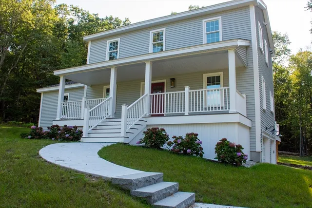 a front view of a house with a garden