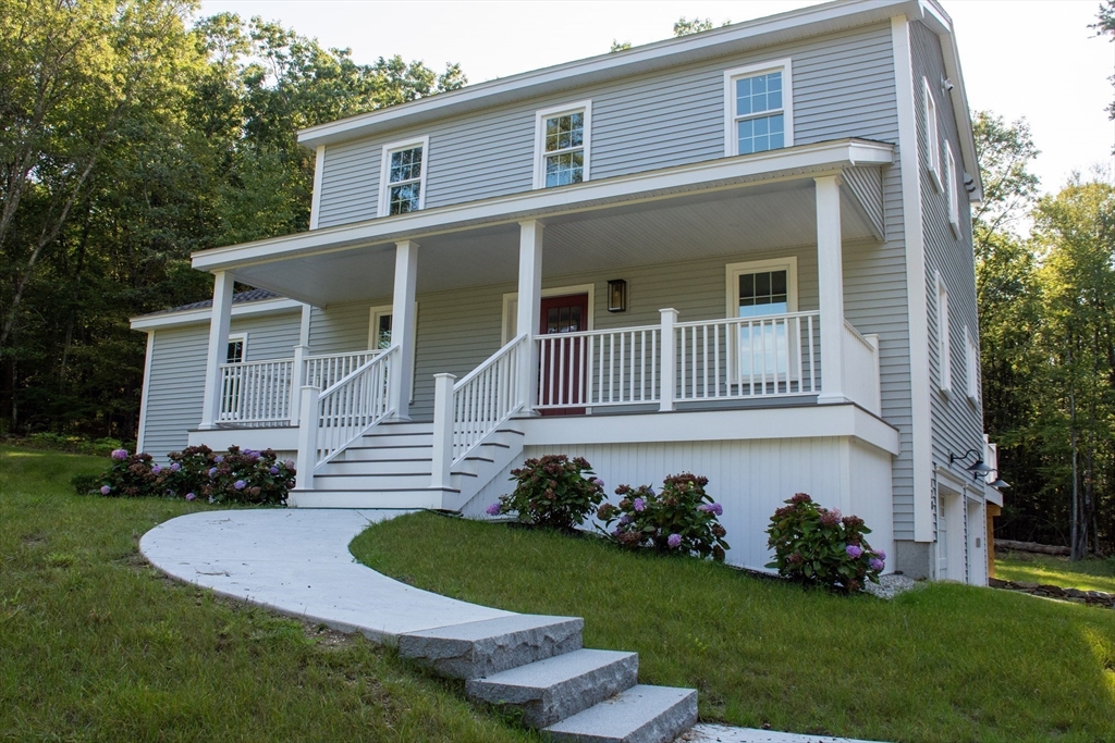 a front view of a house with a garden