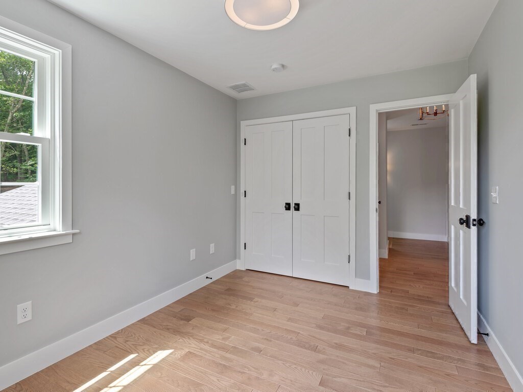 126 Old Southbridge Road Dudley, MA 01571 - Photo 28 of 40 a view of an empty room with wooden floor and window