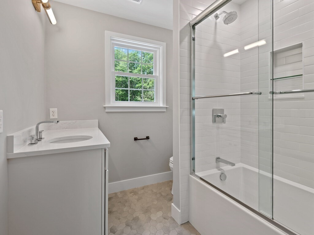 126 Old Southbridge Road Dudley, MA 01571 - Photo 33 of 40 a bathroom with a granite countertop sink toilet and shower