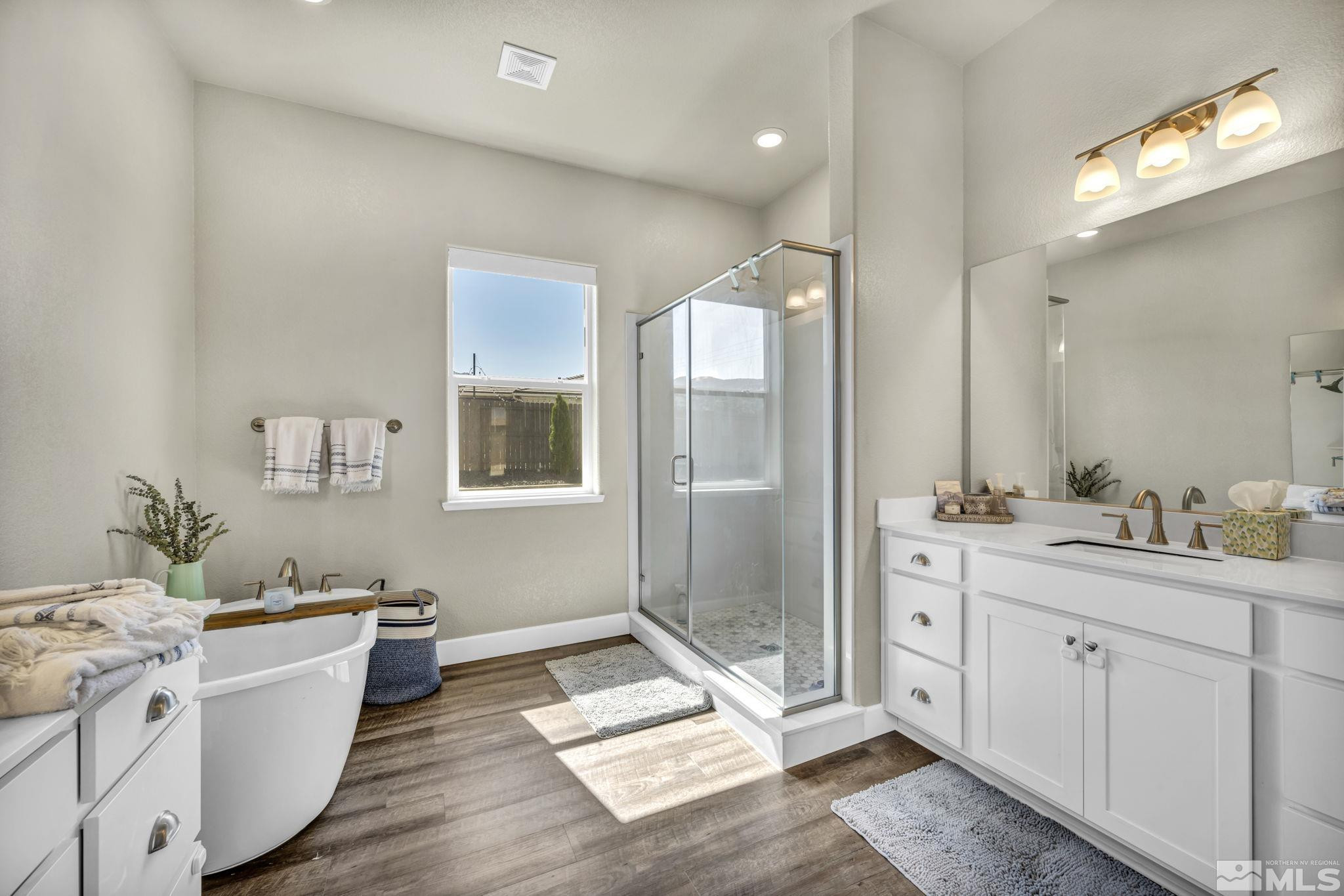 1237 Crawford Crk Drive Reno, NV 89521 - Photo 15 of 39 a spacious bathroom with a double vanity sink a mirror and a bathtub