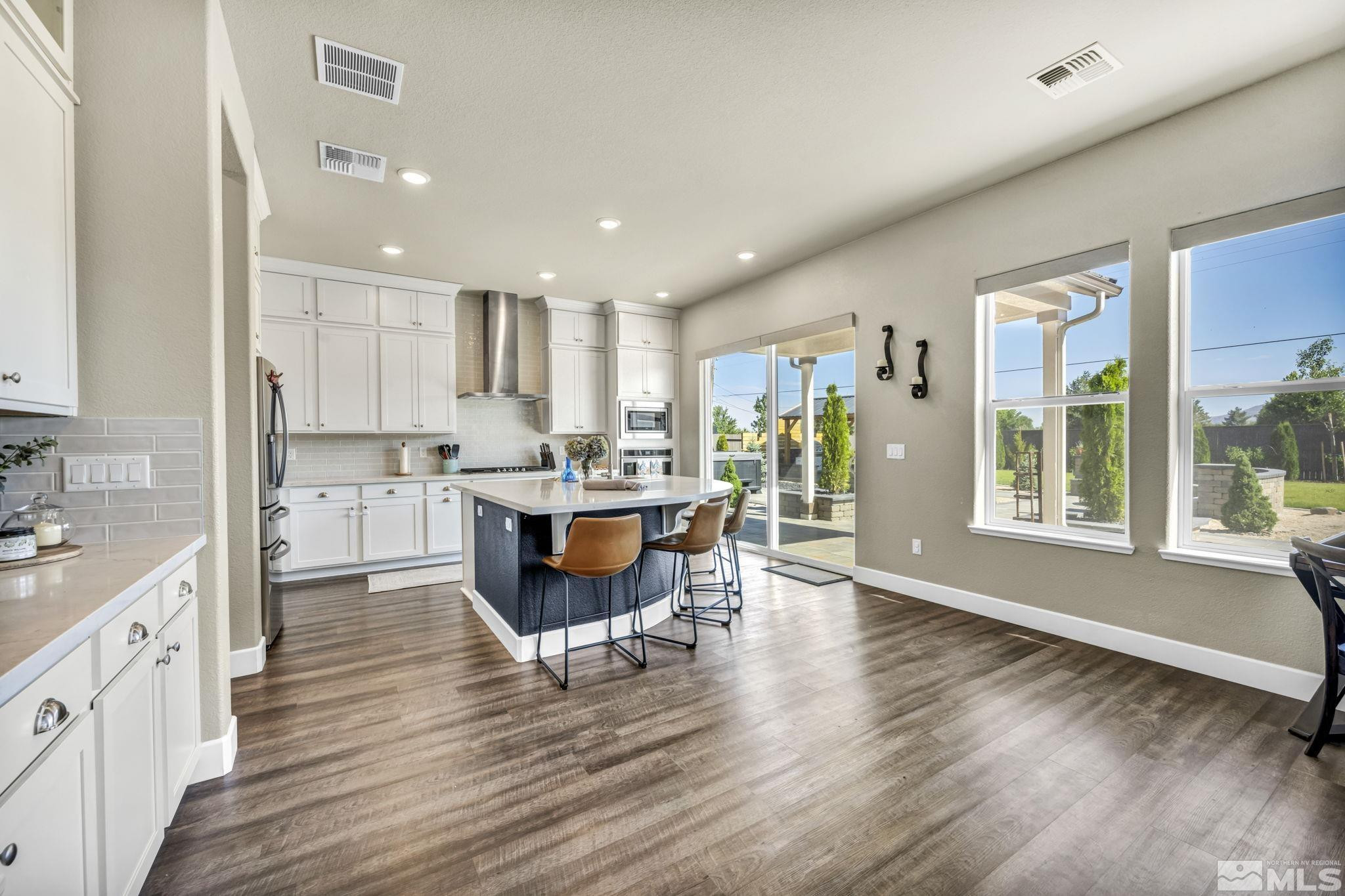 1237 Crawford Crk Drive Reno, NV 89521 - Photo 3 of 39 a open kitchen with white cabinets and stainless steel appliances