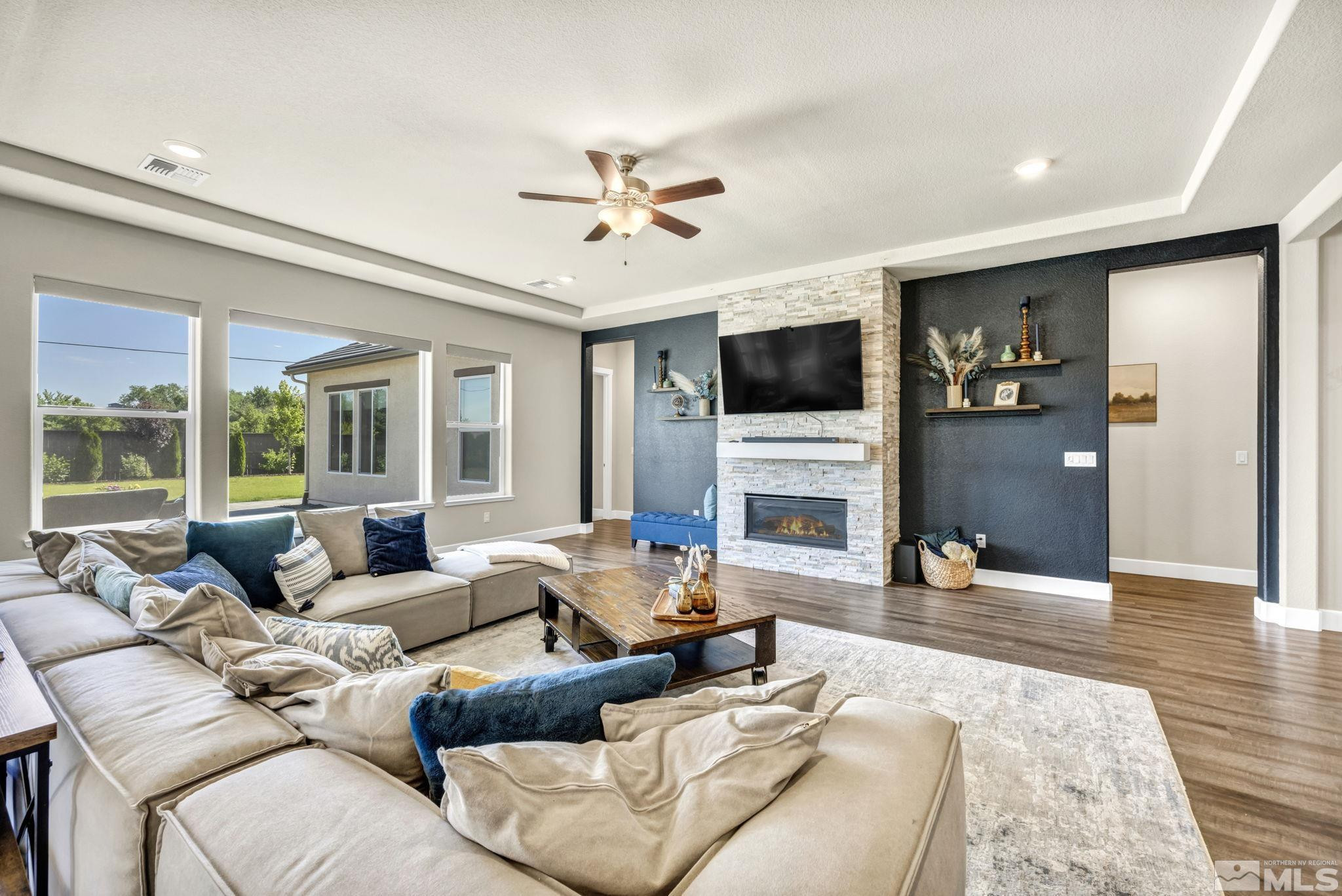 1237 Crawford Crk Drive Reno, NV 89521 - Photo 7 of 39 a living room with furniture large window and a flat screen tv