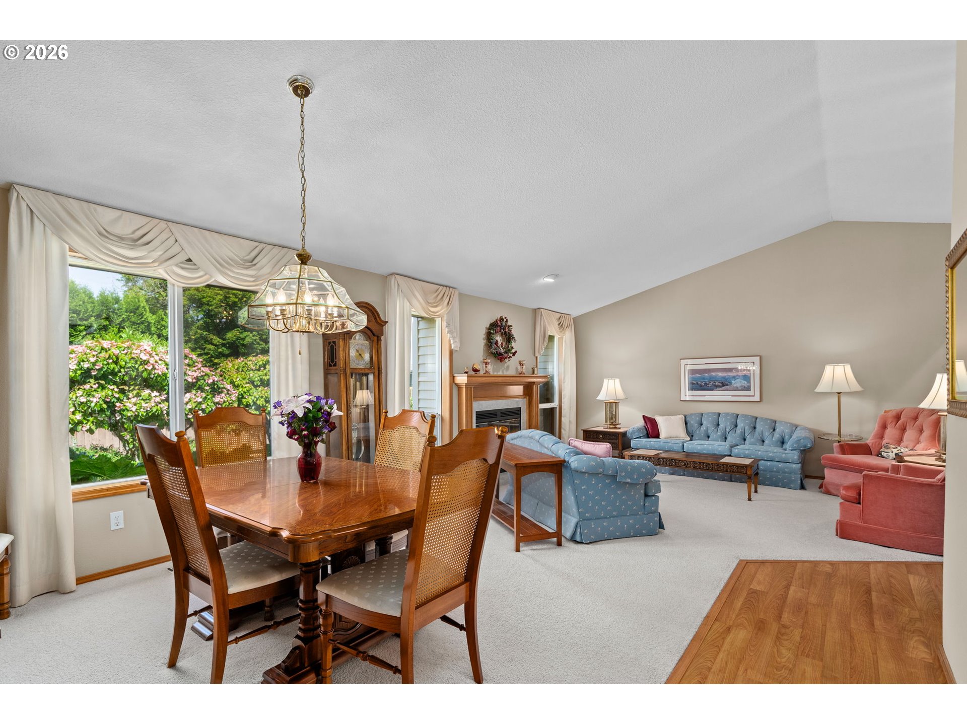 3081 Southwest 31st Street Gresham, OR 97080 - Photo 11 of 38 a view of a dining room and livingroom with furniture wooden floor a chandelier