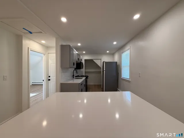 a big room with kitchen view