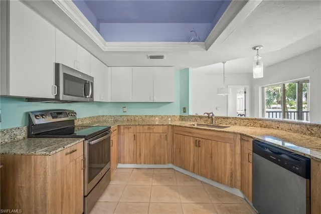 a kitchen with stainless steel appliances granite countertop a sink and stove top oven