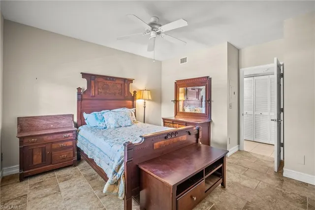 a bedroom with a bed and a dresser in it