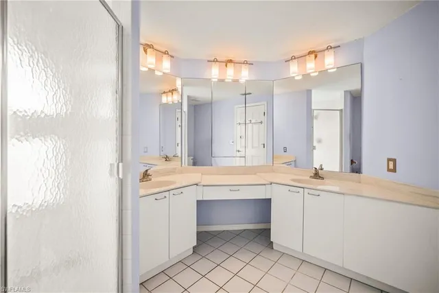 a large bathroom with a sink and mirror