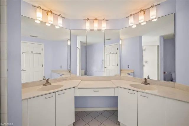 a bathroom with a sink vanity and mirror