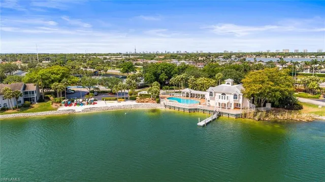 a view of a city with lots of residential buildings ocean and mountain view in back