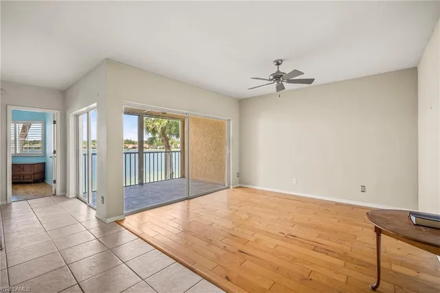 a view of a room with a ceiling fan and window