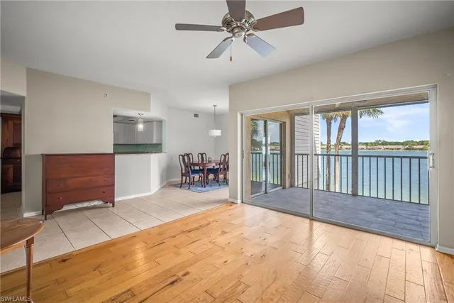 a spacious bedroom with a large bed and a chandelier