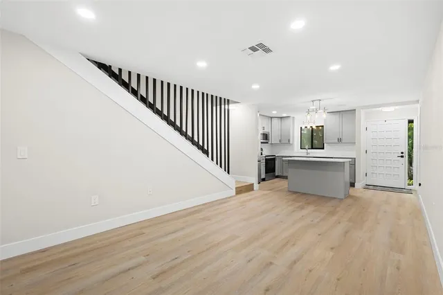 a view of a kitchen with wooden floor and electronic appliances