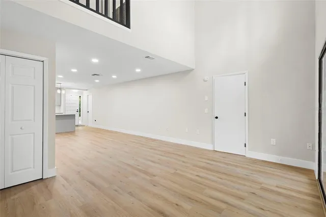 a view of an empty room with wooden floor
