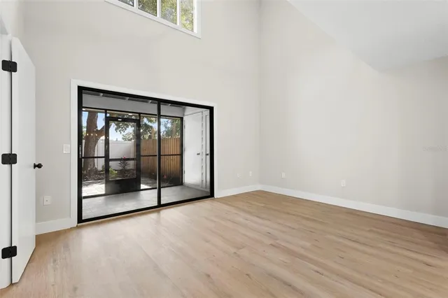a view of an empty room with glass door