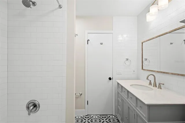 a bathroom with a sink a toilet a shower and a mirror