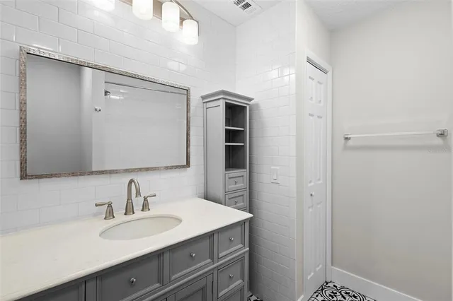 a bathroom with a sink and a mirror