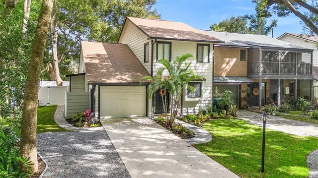 a front view of a house with a yard and potted plants