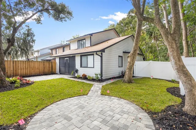 a view of a house with backyard and sitting area
