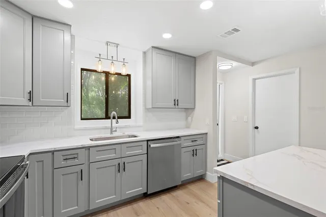 a kitchen with a sink and cabinets