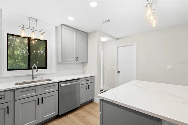 a room with a sink a mirror and a window