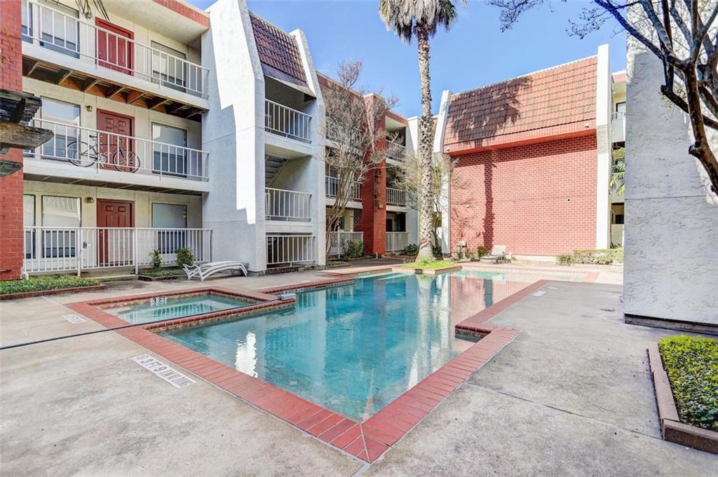 3115 Helms Street, Unit 204 Austin, TX 78705 - Photo 12 of 13 A refreshing pool and spa nestled among apartment buildings offers a serene outdoor escape.