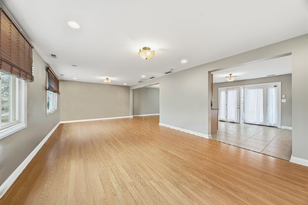 9512 Birch Avenue Mokena, IL 60448 - Photo 5 of 17 a view of an empty room with wooden floor and a window
