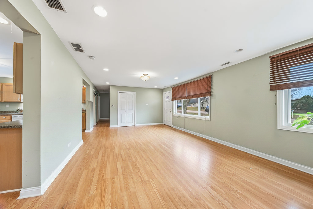 9512 Birch Avenue Mokena, IL 60448 - Photo 9 of 17 a view of an empty room with wooden floor and a window