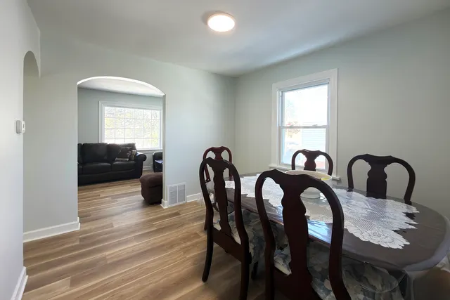 a view of a dining room with furniture and wooden floor