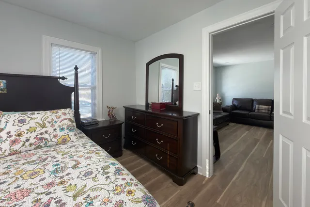 a bedroom with a bed and a dresser