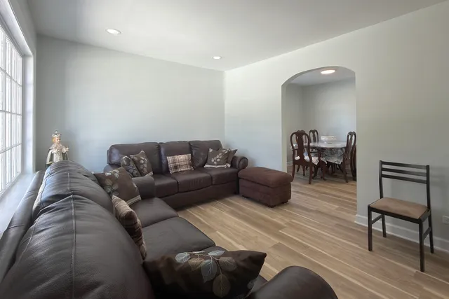a living room with furniture and a wooden floor