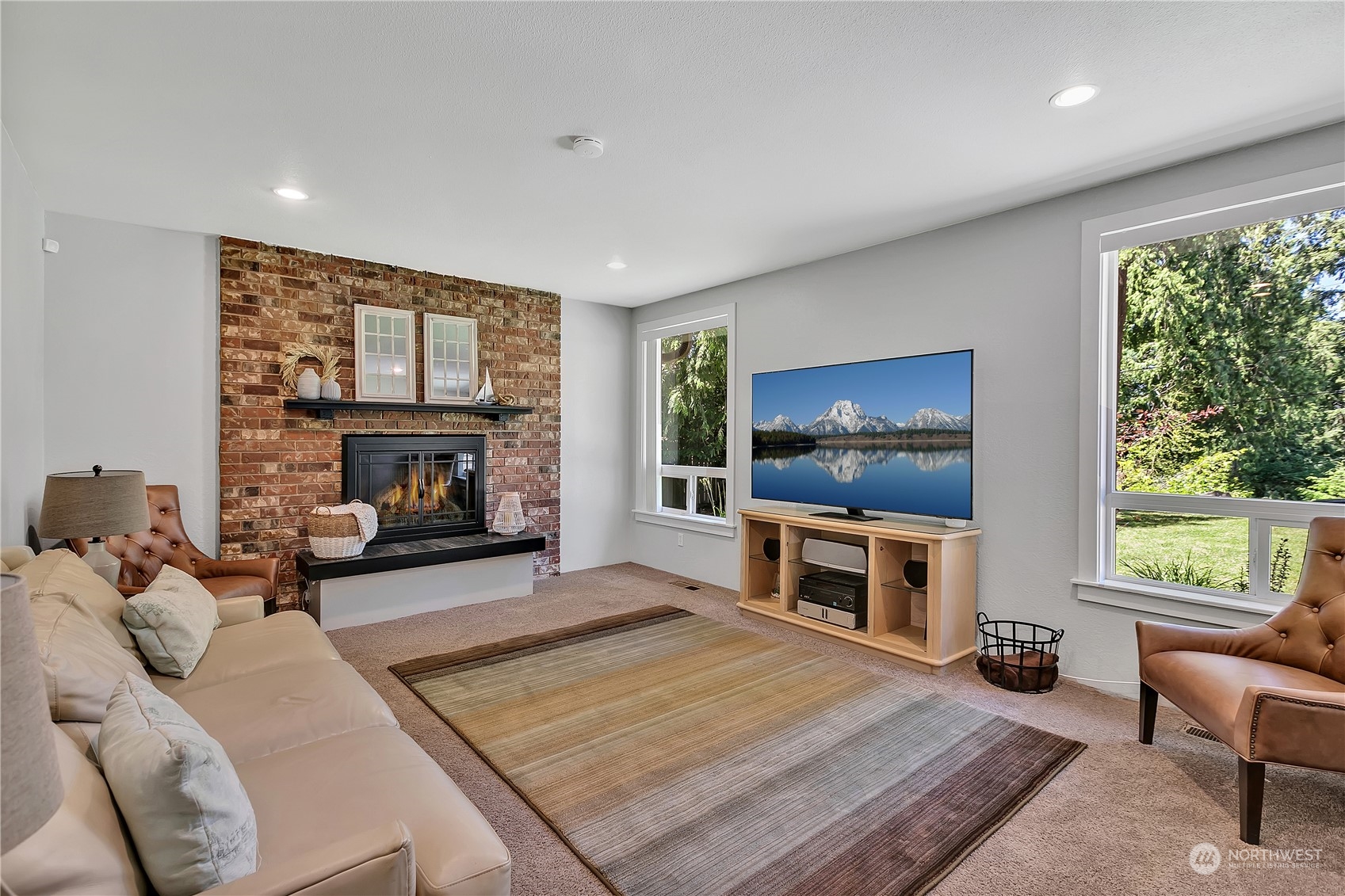 24227 4th Place West Bothell, WA 98021 - Photo 5 of 31 a living room with furniture a flat screen tv and a fireplace