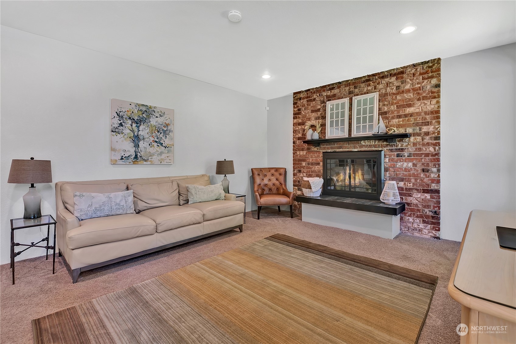 24227 4th Place West Bothell, WA 98021 - Photo 7 of 31 a living room with furniture a flat screen tv and a fireplace
