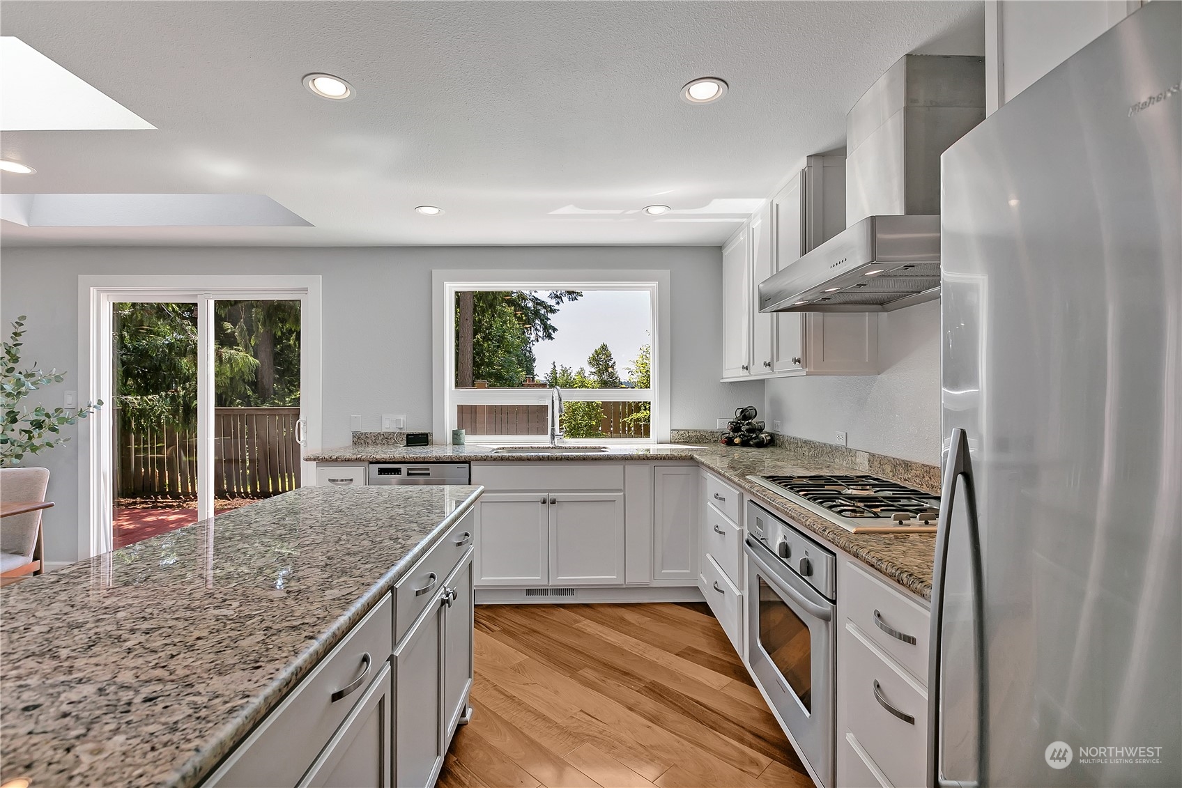 24227 4th Place West Bothell, WA 98021 - Photo 10 of 31 a kitchen with stainless steel appliances granite countertop a stove and a sink