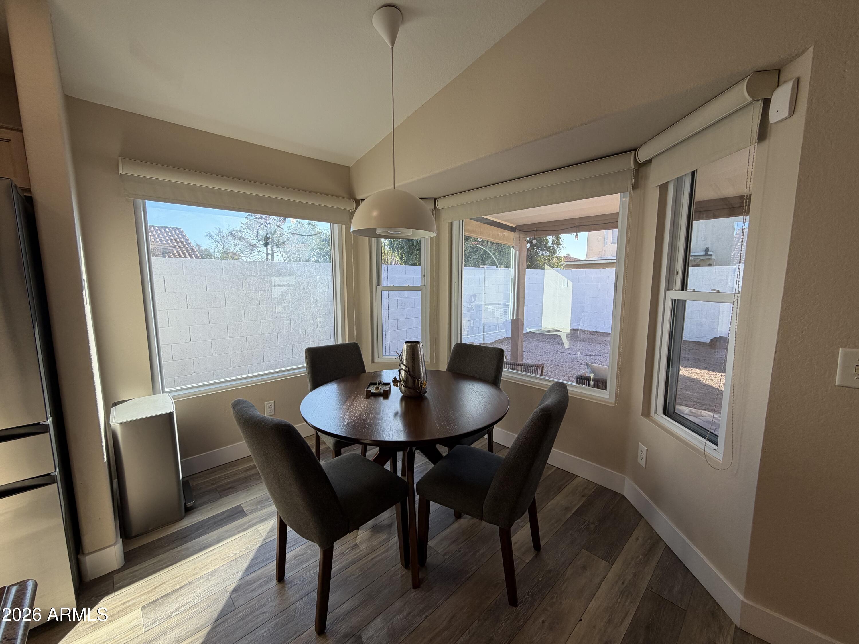 473 West Smoke Tree Road Gilbert, AZ 85233 - Photo 16 of 41 a view of a dining room with furniture window and wooden floor