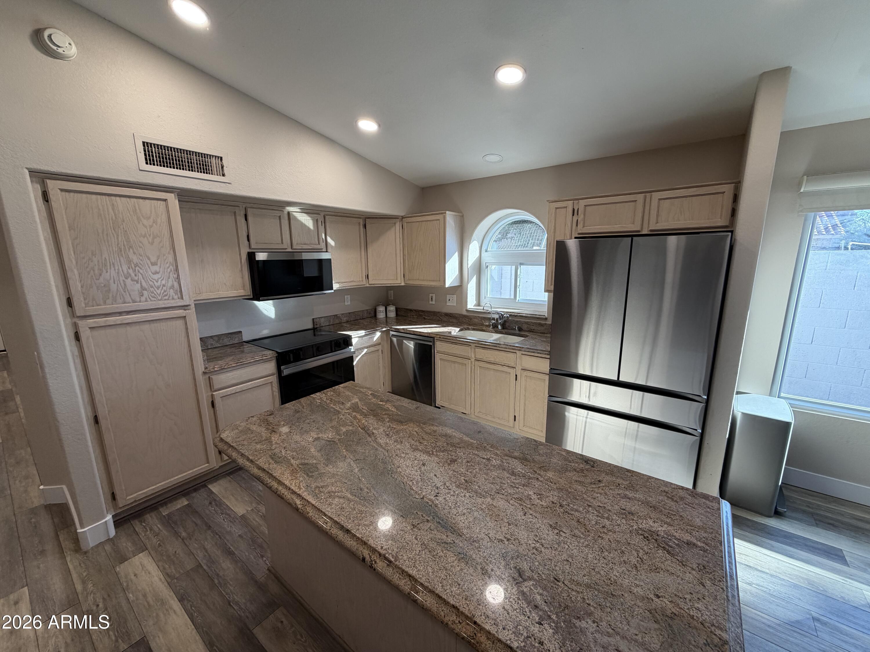 473 West Smoke Tree Road Gilbert, AZ 85233 - Photo 18 of 41 a kitchen with stainless steel appliances a refrigerator stove microwave and sink