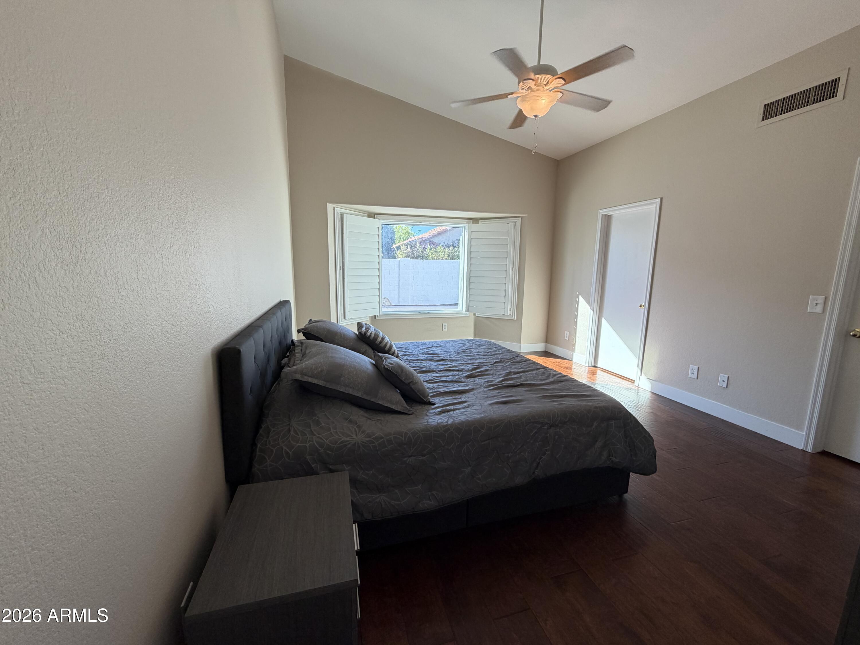 473 West Smoke Tree Road Gilbert, AZ 85233 - Photo 20 of 41 a bedroom with a bed and a chandelier