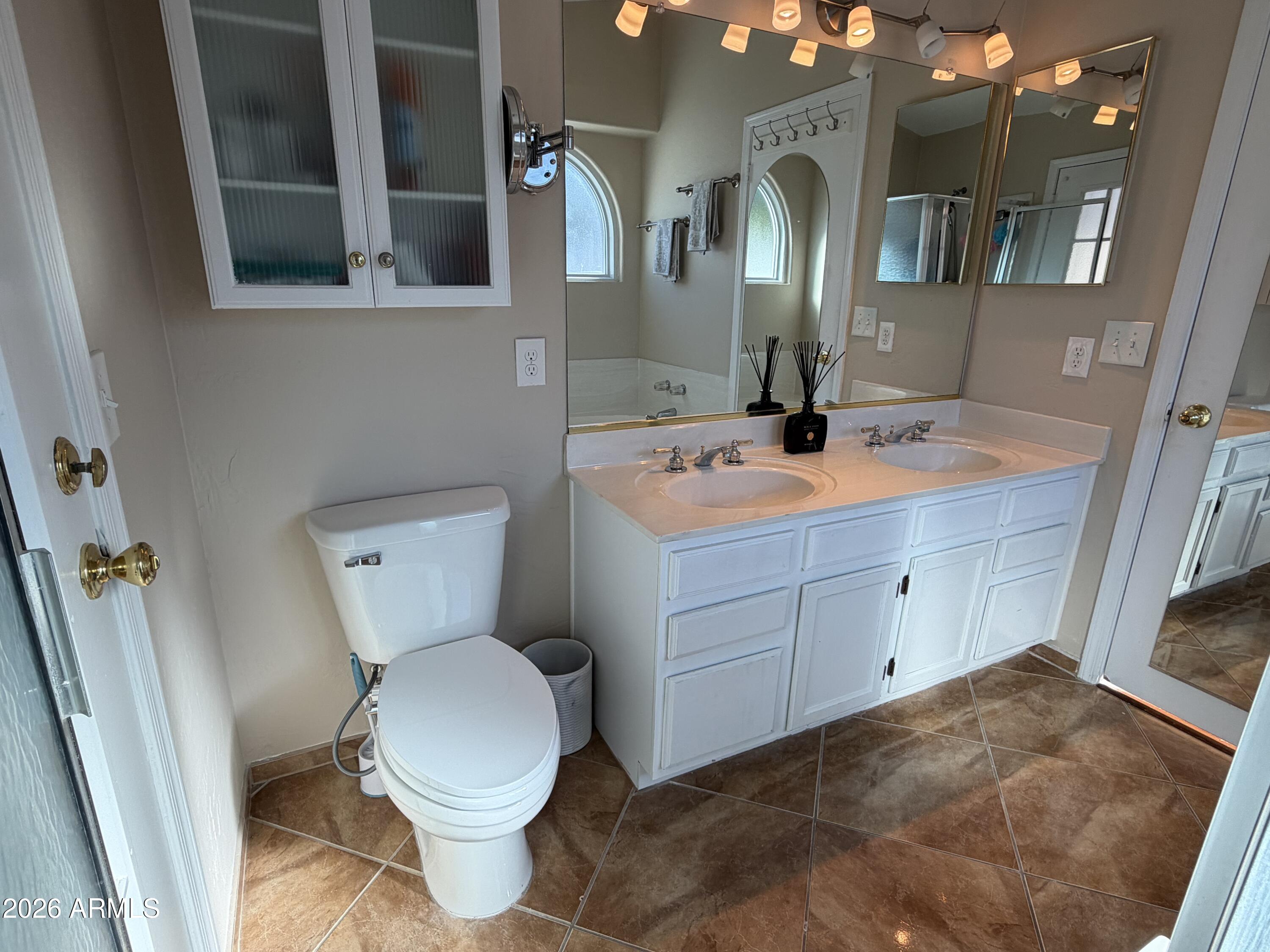 473 West Smoke Tree Road Gilbert, AZ 85233 - Photo 22 of 41 a bathroom with a toilet sink and mirror