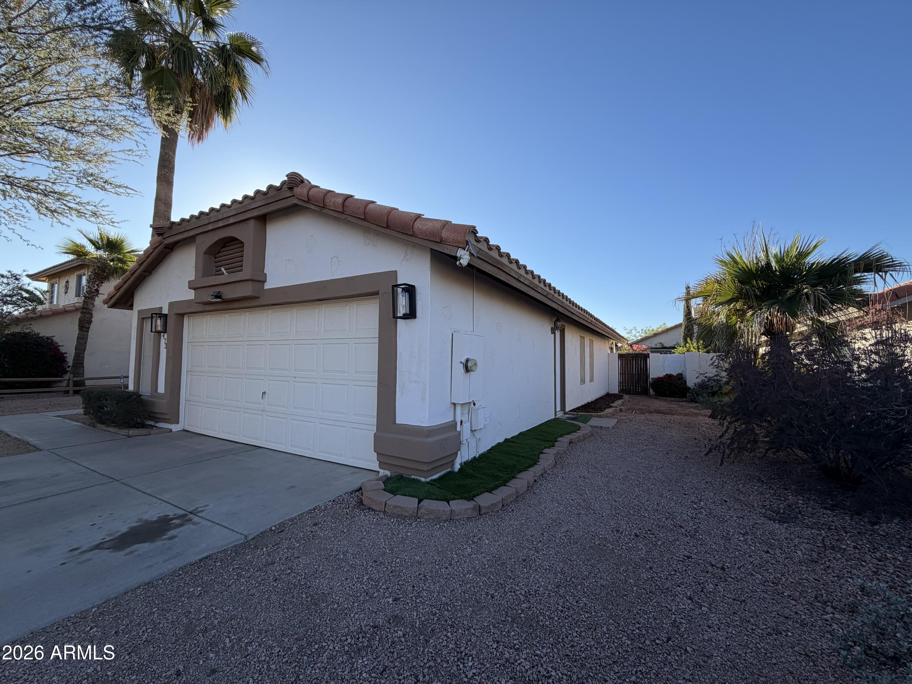 473 West Smoke Tree Road Gilbert, AZ 85233 - Photo 4 of 41 a front view of a house with a yard and garage