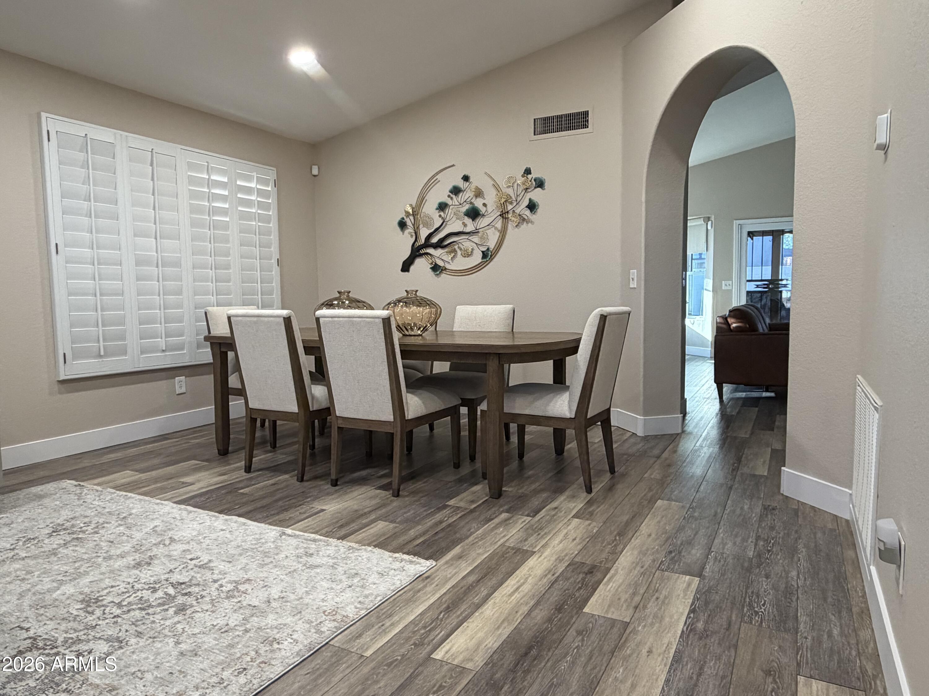 473 West Smoke Tree Road Gilbert, AZ 85233 - Photo 8 of 41 a view of a dining room with furniture and wooden floor