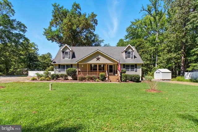 a front view of a house with swimming pool and porch