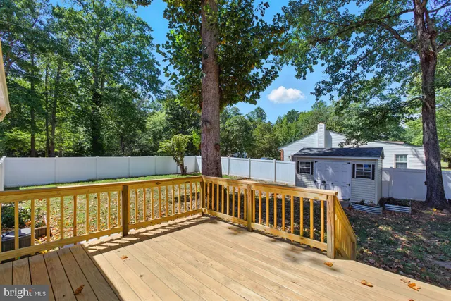 a view of balcony with wooden floor and fence