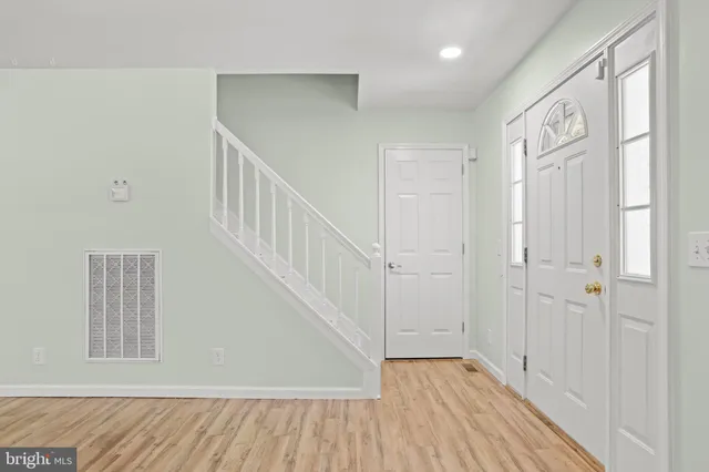 a view of an entryway with wooden floor