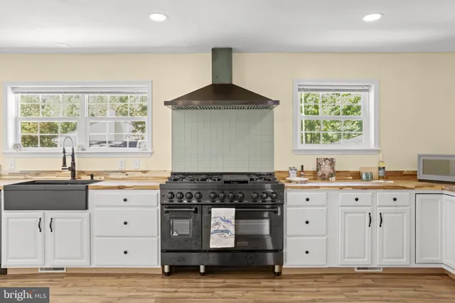 a kitchen with granite countertop a stove and a sink